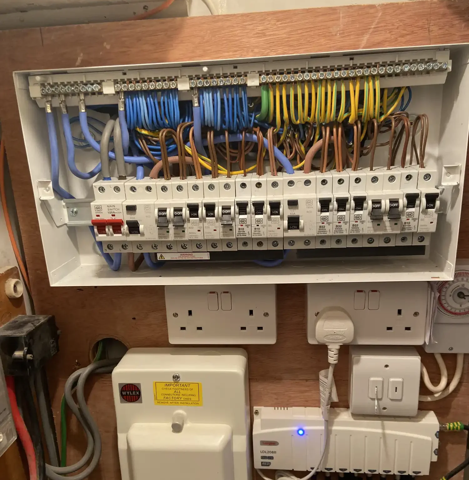 Expert electrician fixing circuit breaker in Harpenden home.